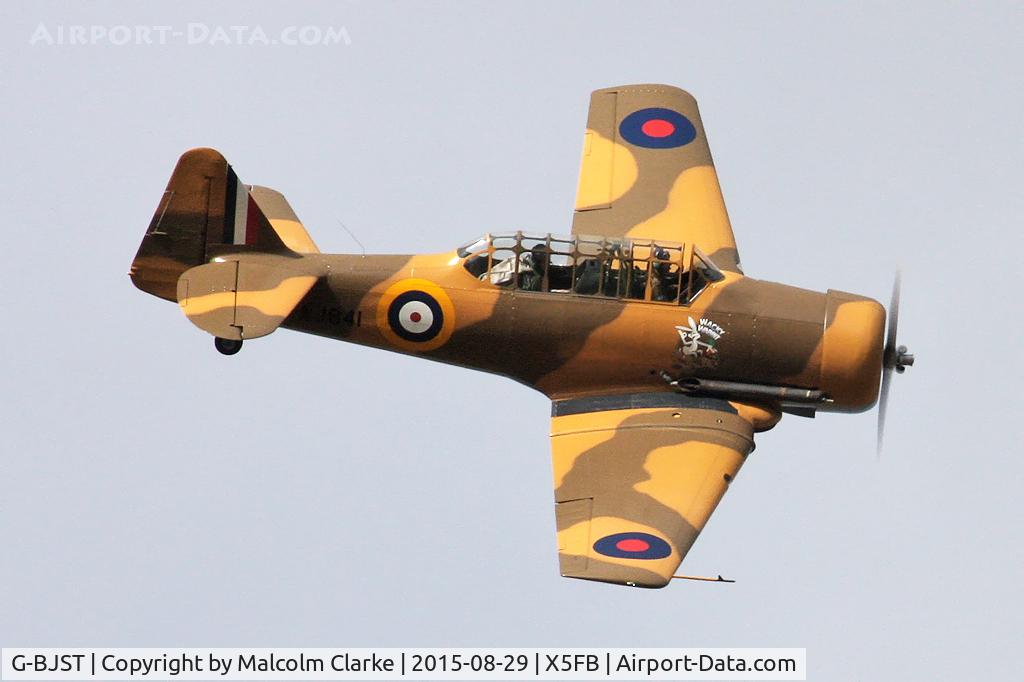 G-BJST, 1953 Canadian Car & Foundry T-6H Harvard Mk.4M C/N 14A-2429, Canadian Car & Foundry T-6H Harvard Mk4M, after an impromptu aerobatic display, leaves for Duxford in her new camouflage paint scheme. Fishburn Airfield, August 29th 2015.