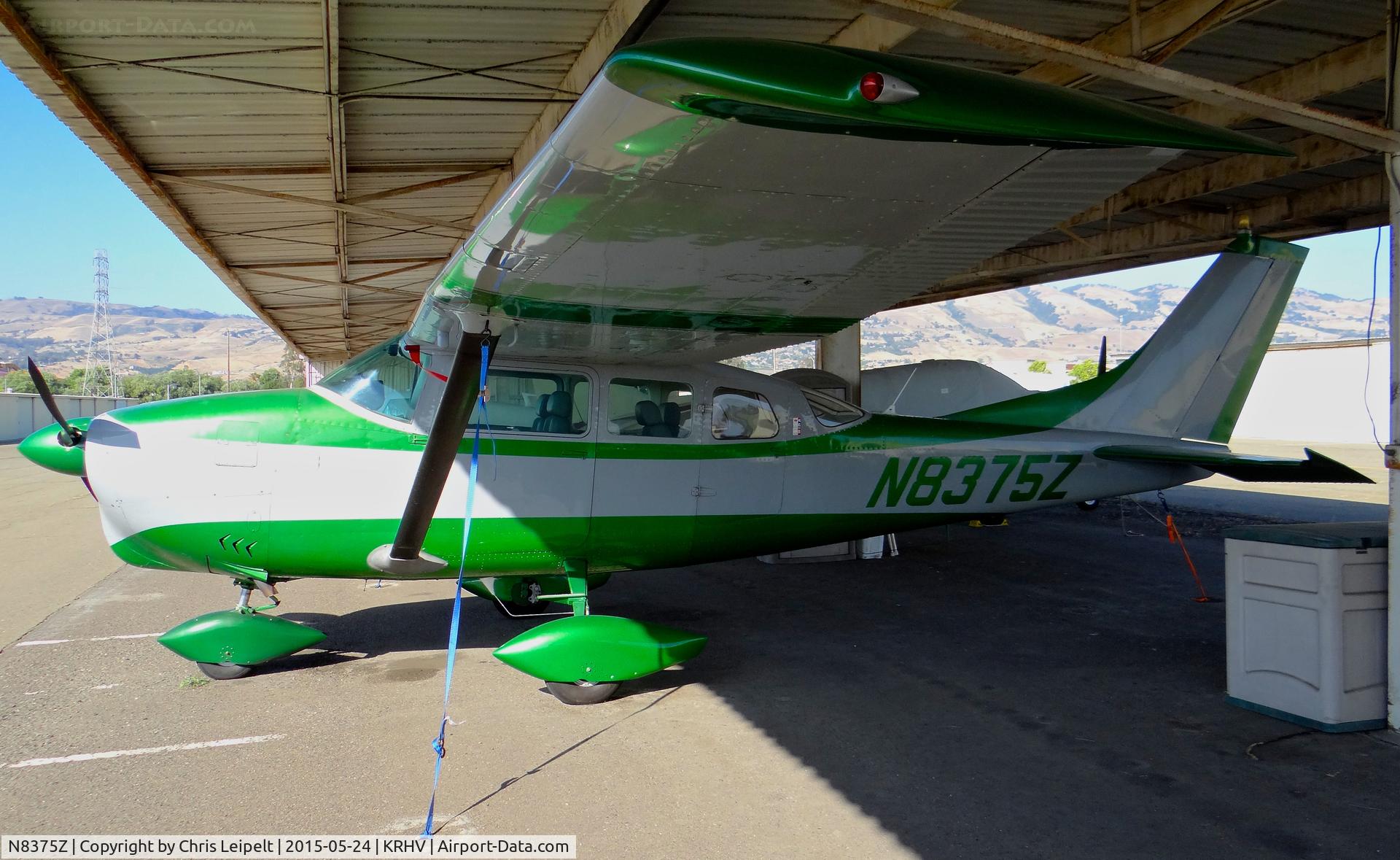 N8375Z, 1963 Cessna 210-5(205) C/N 205-0375, Locally-based bright green 1963 Cessna 210 sitting at its tie down under the shelters at Reid Hillview Airport, San Jose, CA.