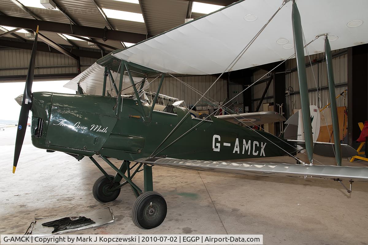 G-AMCK, 1941 De Havilland DH-82A Tiger Moth II C/N 84641, In hangar at Liverpool Flying School with Harvard in RAF training livery behind.