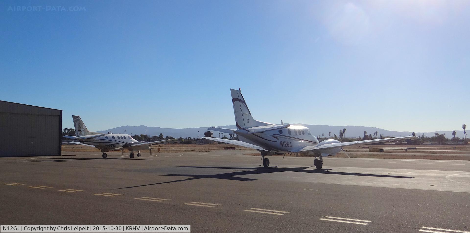 N12GJ, 1972 Beech E-90 King Air C/N LW-12, Locally-based 1972 Beechcraft King Air E-90 sitting on the ramp while another local King Air C90B taxis out for departure at Reid Hillview Airport, San Jose, CA.