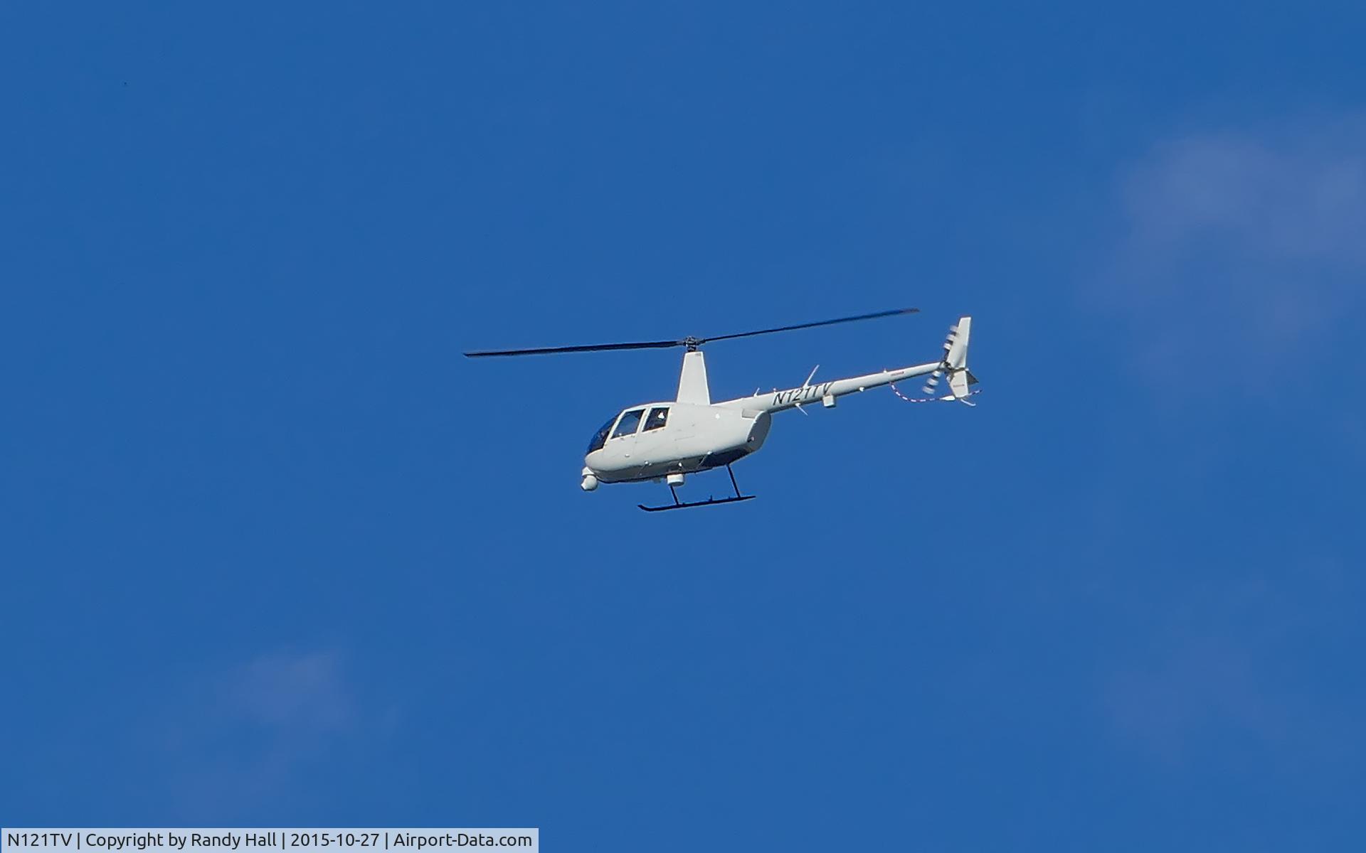 N121TV, Robinson R44 II C/N 13214, N121TV hovering, circling , monitoring some police activity for about an hour on 10/27/2015 taken approx 9 AM in the vicinity of I-30 and Eastchase Pkwy in far east Ft. Worth / west Arlington Texas, appears unmarked except for tail number.