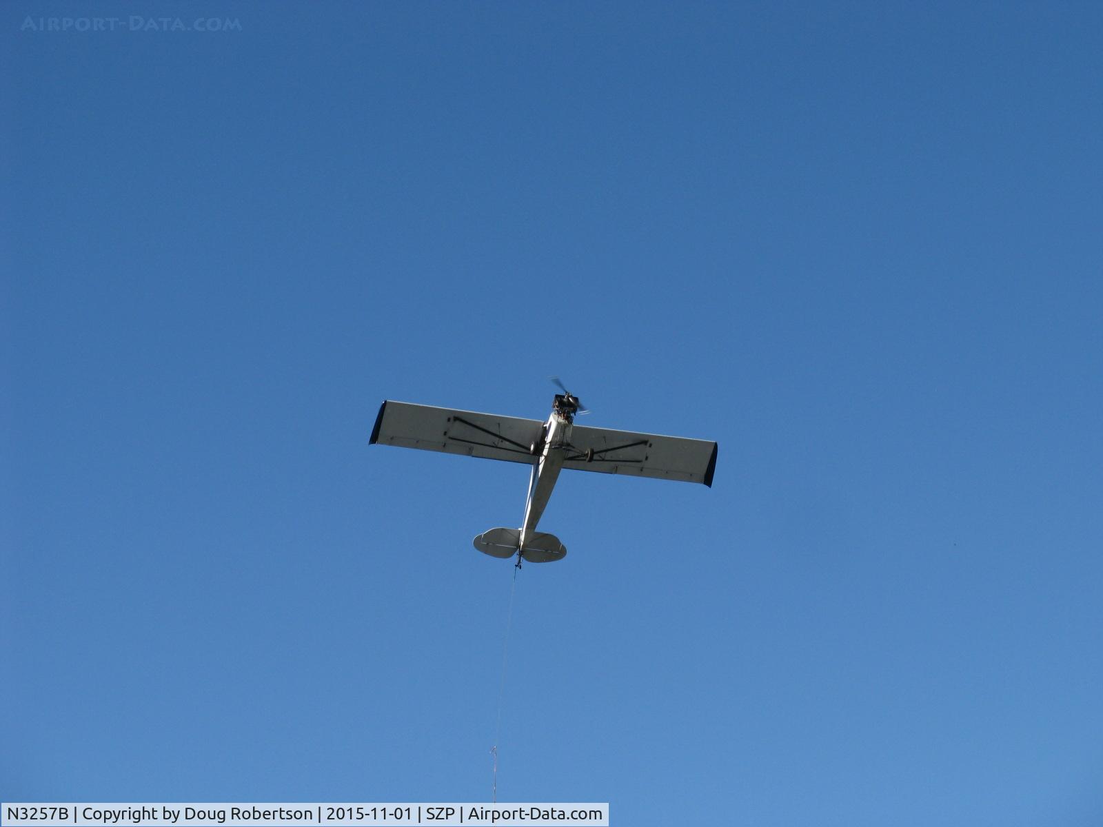 N3257B, 1954 Piper PA-18-135 Super Cub C/N 18-3275, 1954 Piper PA-18-135 SUPER CUB, Lycoming O-320 upgrade, larger wings, aileron fences, droop tips. Restricted class aerial advertising. Steep power climb on first try successful banner pickup from Rwy 04R grass. A real Pro at work!