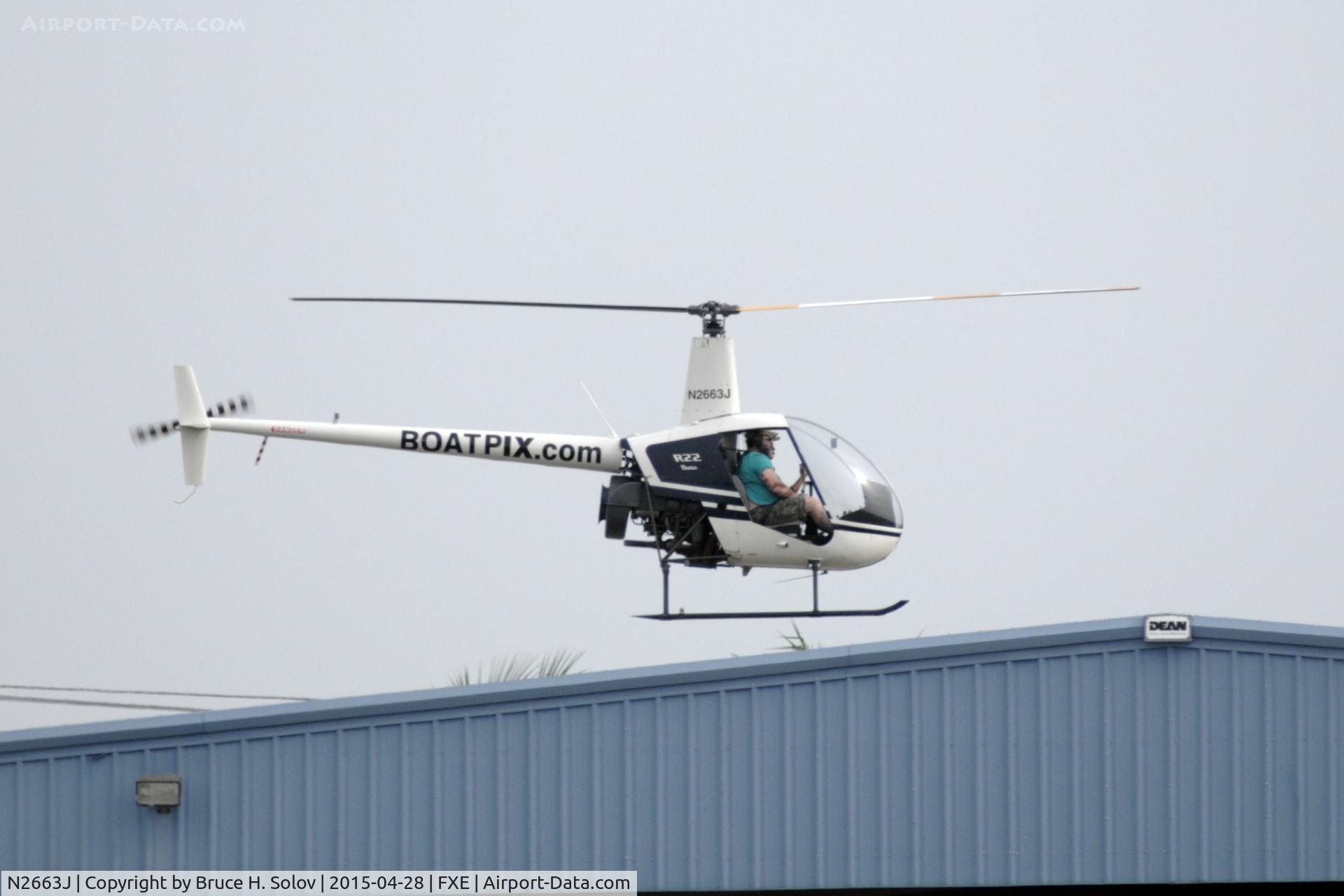 N2663J, 1988 Robinson R22 BETA C/N 0877, hovering over the field