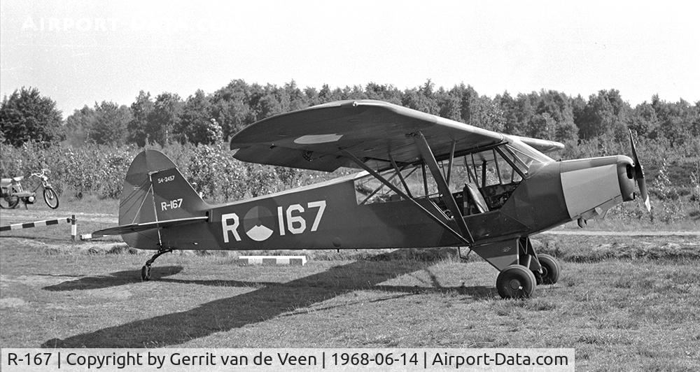 R-167, 1954 Piper L-21B Super Cub (PA-18-135) C/N 18-3857, This dayglow nosed 54-2447 parked at Ermelo LAS, check out my (mothers) moped in the background!