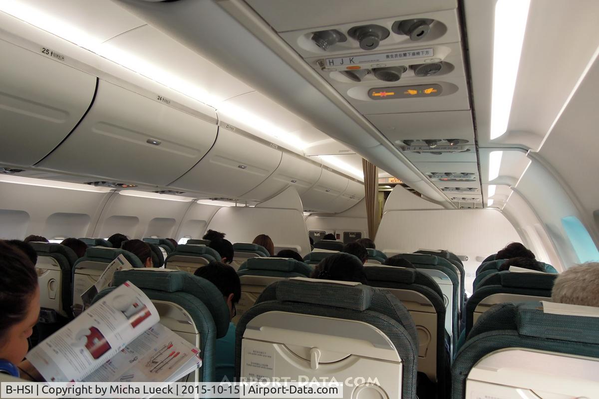 B-HSI, 1999 Airbus A320-232 C/N 0930, Nice clean cabin. Some people struggled with the electronic overhead lockers... (NGB-HKG)