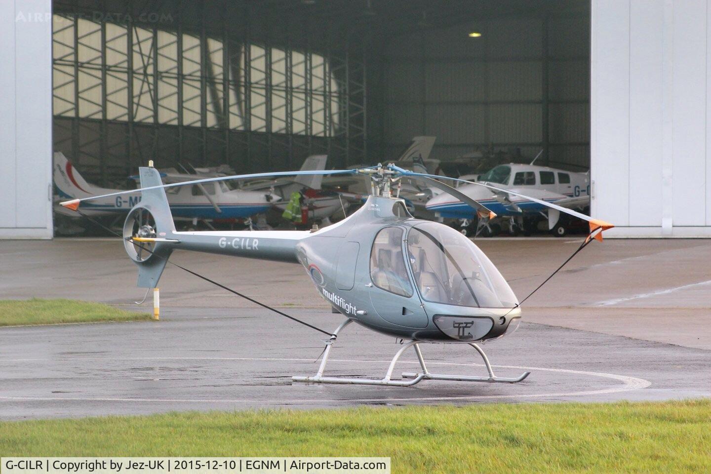 G-CILR, 2014 Guimbal Cabri G2 C/N 1090, In front of main hanger with some of Multiflight flleet in doorway,