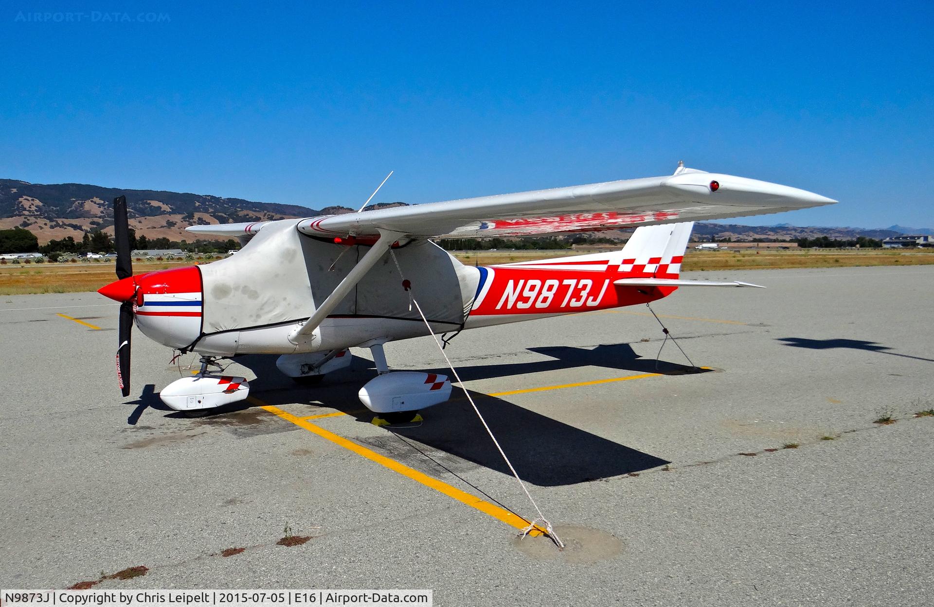 N9873J, 1976 Cessna A150M Aerobat C/N A1500682, Locally-based 1976 Cessna A150M parked at the south tie downs at South County Airport, San Martin, CA.