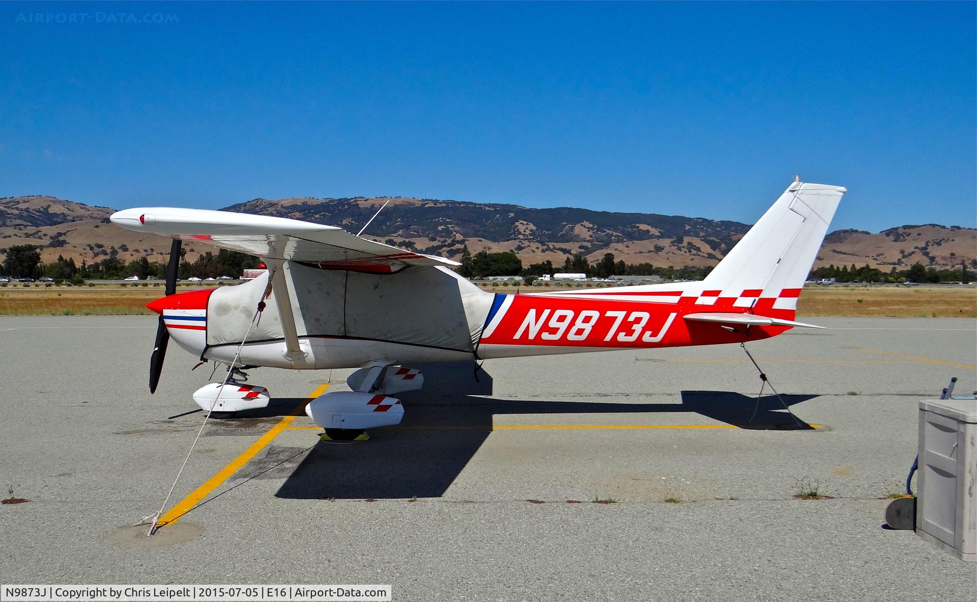 N9873J, 1976 Cessna A150M Aerobat C/N A1500682, Locally-based 1976 Cessna A150M parked at the south tie downs at South County Airport, San Martin, CA.