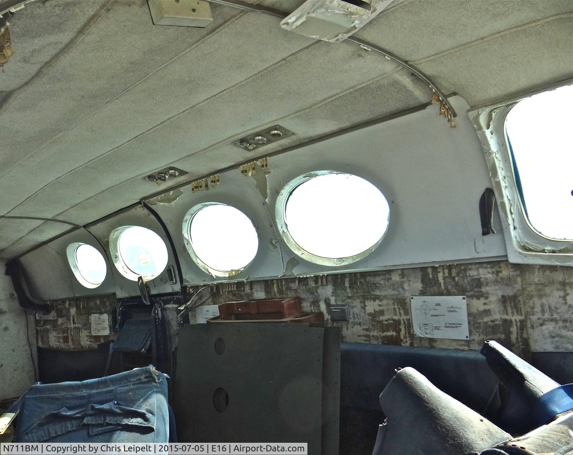N711BM, 1966 Cessna 411 C/N 411-0220, Cabin shot of a poor old locally-based 1966 Cessna 411 parked at the south tie downs at South County Airport, San Martin, CA. It is one of the two rotting C411s at E16 and this one hasn't been touched in years.