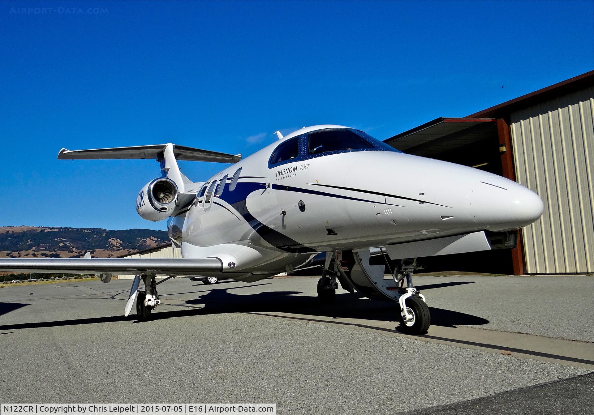 N122CR, 2013 Embraer EMB-500 Phenom 100 C/N 50000315, Locally-based 2013 Embraer Phenom 100 parked in front of its hangar at South County Airport, San Martin, CA. Owned by Christopher Ranch LLC, a garlic farm out of nearby Gilroy.