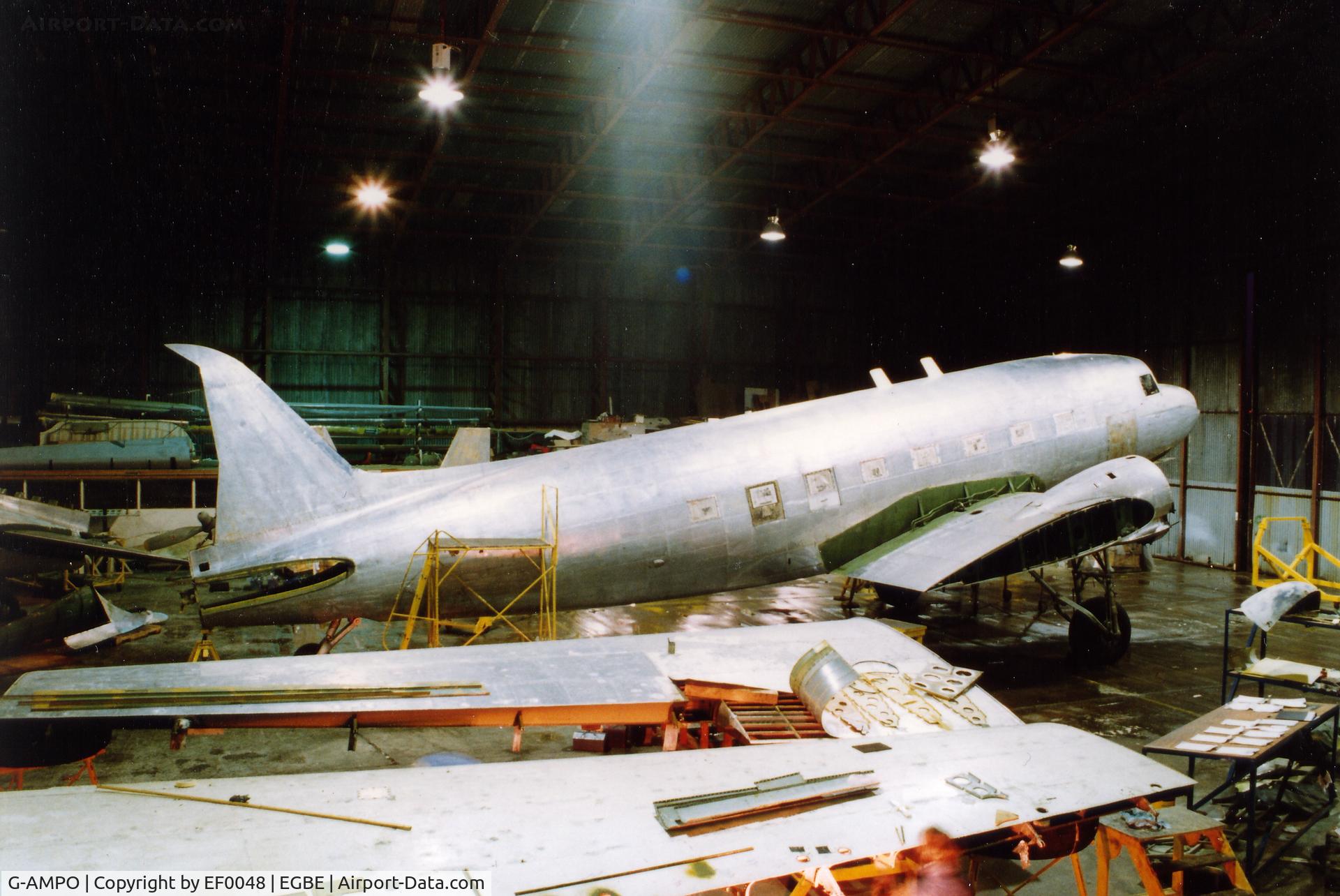 G-AMPO, 1944 Douglas DC-3C-R-1830-90C (C-47B) C/N 33186, A rare shot of PO being restored to spray config 1990. scanned from slide