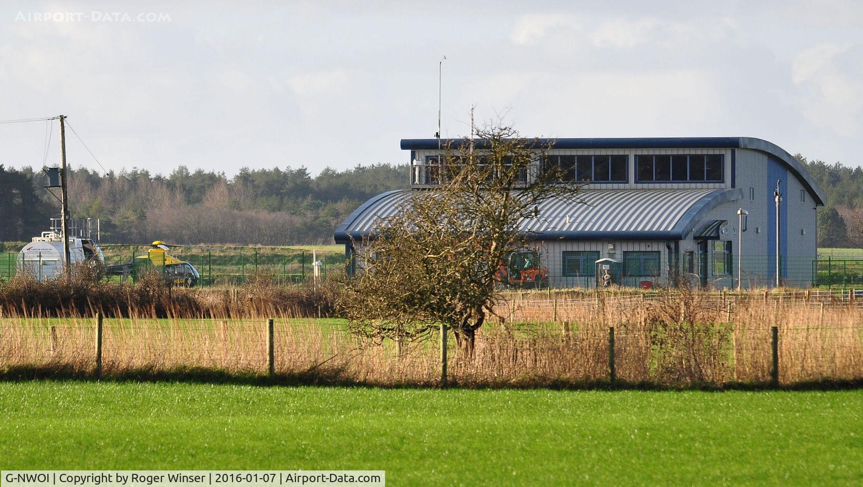 G-NWOI, 2010 Eurocopter EC-135P-2+ C/N 0887, Off airport. Distant shot of the NPAS helicopter deployed to the Dyfed-Powys Police helipad at Pembrey, Wales, UK.