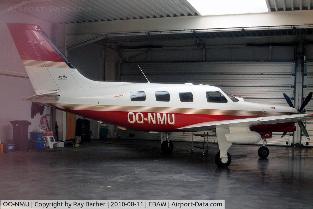 OO-NMU, Piper PA-46-350P Malibu Mirage C/N 4636132, Piper PA-46-350P Malibu Mirage JetPROP DLX [4636132] Antwerp-Deurne~OO 11/08/2010. Taken through glass of hangar window.