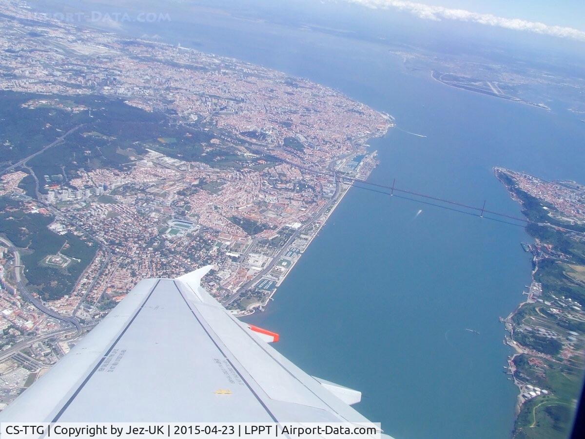 CS-TTG, 1998 Airbus A319-111 C/N 906, overwing shot from leaving LPPT with most of Lisbon and surrounding areas visible, on route to EGCC