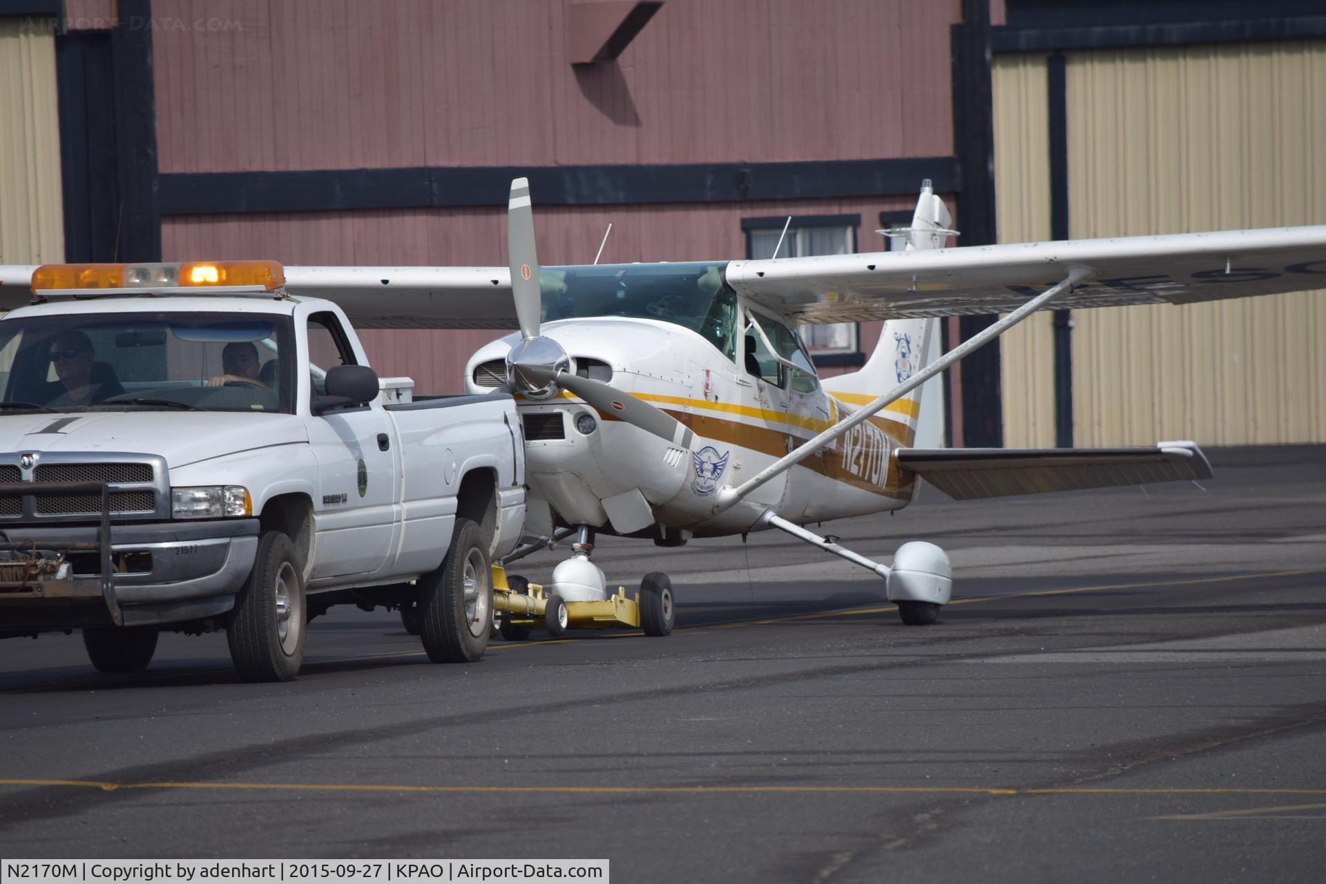 N2170M, 1976 Cessna 182P Skylane C/N 18265133, N2170M being towed to the ramp following an emergency landing due to a front gear flat tire.