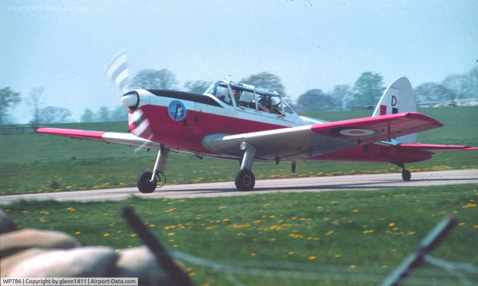 WP786, 1952 De Havilland DHC-1 Chipmunk T.10 C/N C1/0677, RAF serial number WP 786 pictured here by myself at its base in 1984 RAF Leeming North Yorkshire , taxing past a perimeter fire gate on route to the main runway for take off on a nice spring day,