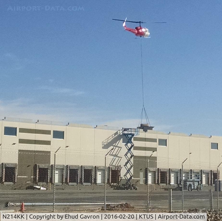 N214KK, 1964 Bell UH-1H Iroquois C/N 4267 (64-13560), N214KK lowering an HVAC unit at distribution facility roof, 1 mile NE of Tucson International Airport.
