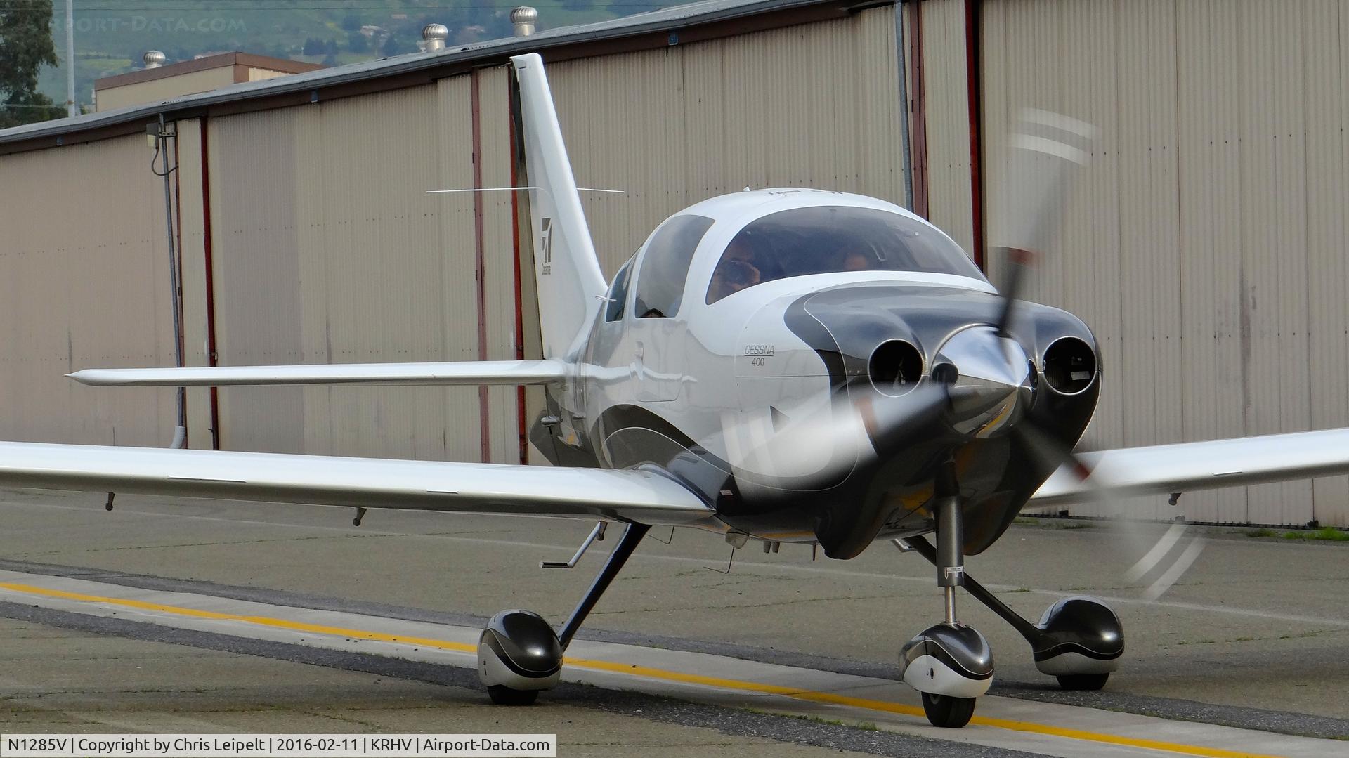 N1285V, 2008 Cessna LC41-550FG C/N 411085, Locally-based 2008 Cessna 400 with passenger taking a picture of me taking a picture of him at Reid Hillview Airport, San Jose, CA.