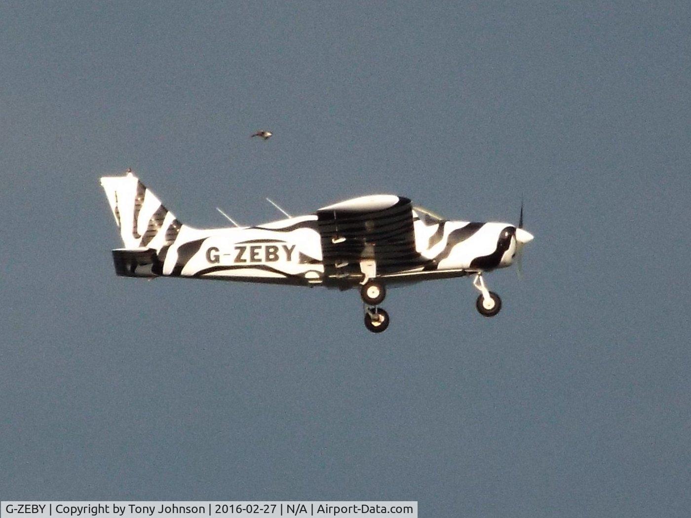G-ZEBY, 1973 Piper PA-28-140 Cherokee E C/N 28-7325240, Taken from Scarborough Esplanade Gardens, North Yorkshire, as the aircraft unexpectedly flew past over the sea, almost at the same height.