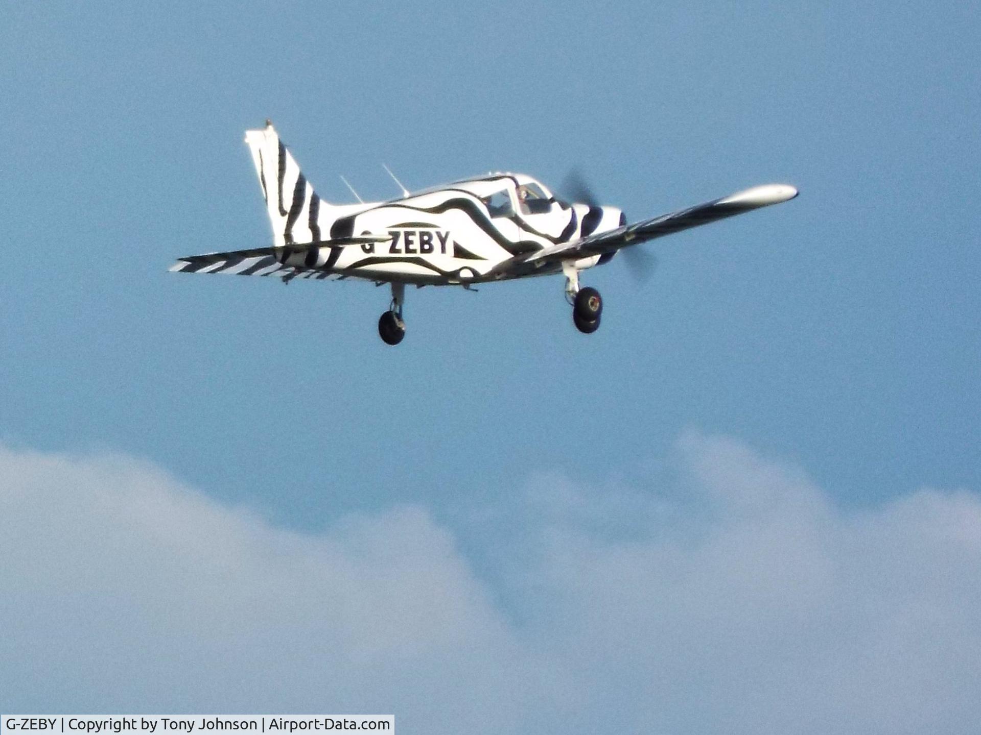 G-ZEBY, 1973 Piper PA-28-140 Cherokee E C/N 28-7325240, Taken from Scarborough Esplanade Gardens, North Yorkshire, as the aircraft unexpectedly flew past over the sea, almost at the same height.
