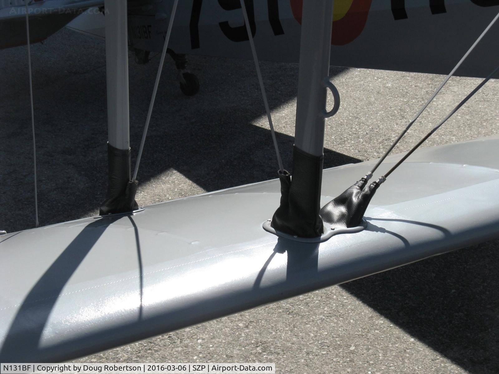 N131BF, 1963 CASA 1-131 Jungmann C/N E3B-629, 1963 C.A.S.A. 1.131 BUCKER JUNGMANN, E.N.M.A. GIV Series, leather turnbuckle boots typical of lightweight design parameters in production Bucker 1.131s, closeup on lower wing