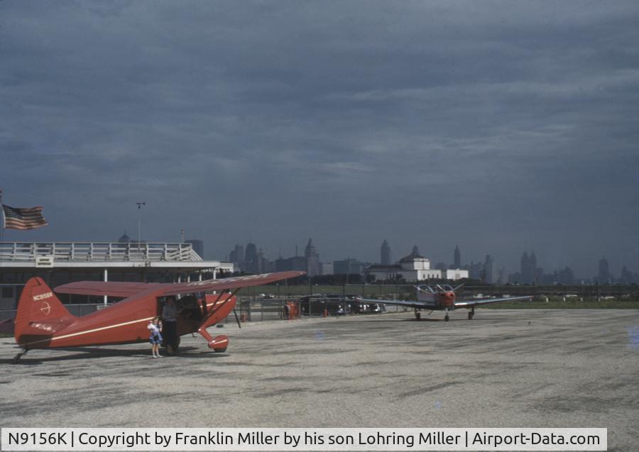 N9156K, Stinson 108-1 Voyager C/N 1082156, This photo probably was taken at Meigs Field in Chicago.  The white building in the background seems to match the one in the aerial picture beside the causeway under The Airport Opens at http://friendsofmeigs.org/html/history/meigs_history.htm