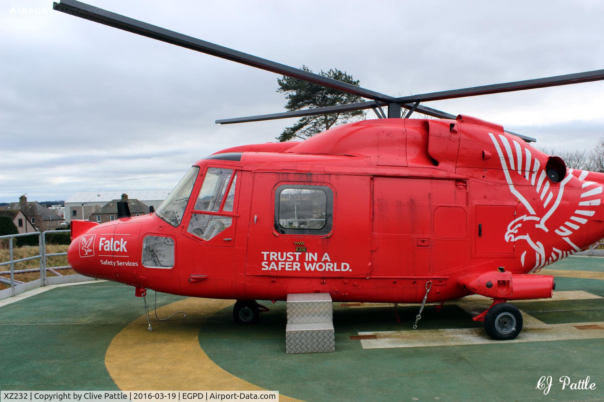 XZ232, 1977 Westland Lynx HAS.3GMS C/N 009, In use as a training aid at the Falck Safety Services premises at Dyce, Aberdeen, over the north-east fence from Aberdeen airport EGPD. Mounted on a mock helipad for students of the oil industry. Last served with RN 702 NAS coded 632