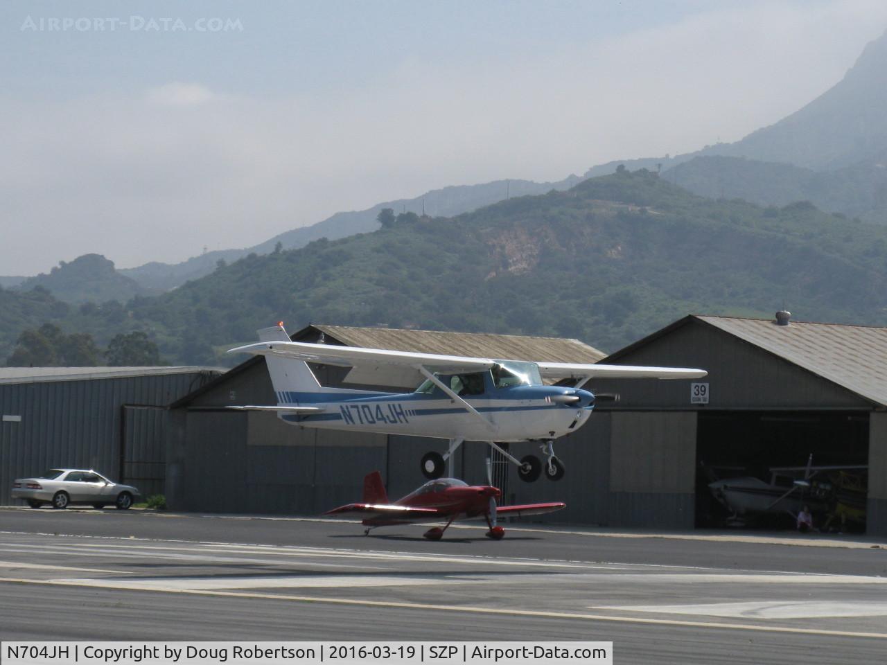 N704JH, 1976 Cessna 150M C/N 15078644, 1976 Cessna 150M, Continental O-200 100 Hp,  landing Rwy 22 with N406P taxiing below and beyond-A TWOFER!