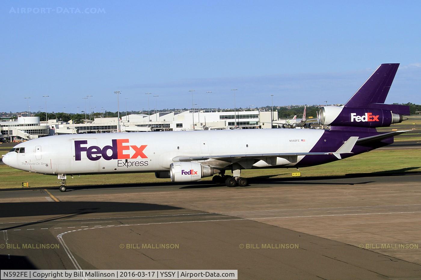 N592FE, 1992 McDonnell Douglas MD-11F C/N 48550, TAXIING TO CARGO BAYS.  TAKEN THRU THE GLASS OF DEPARTURES LOUNGE