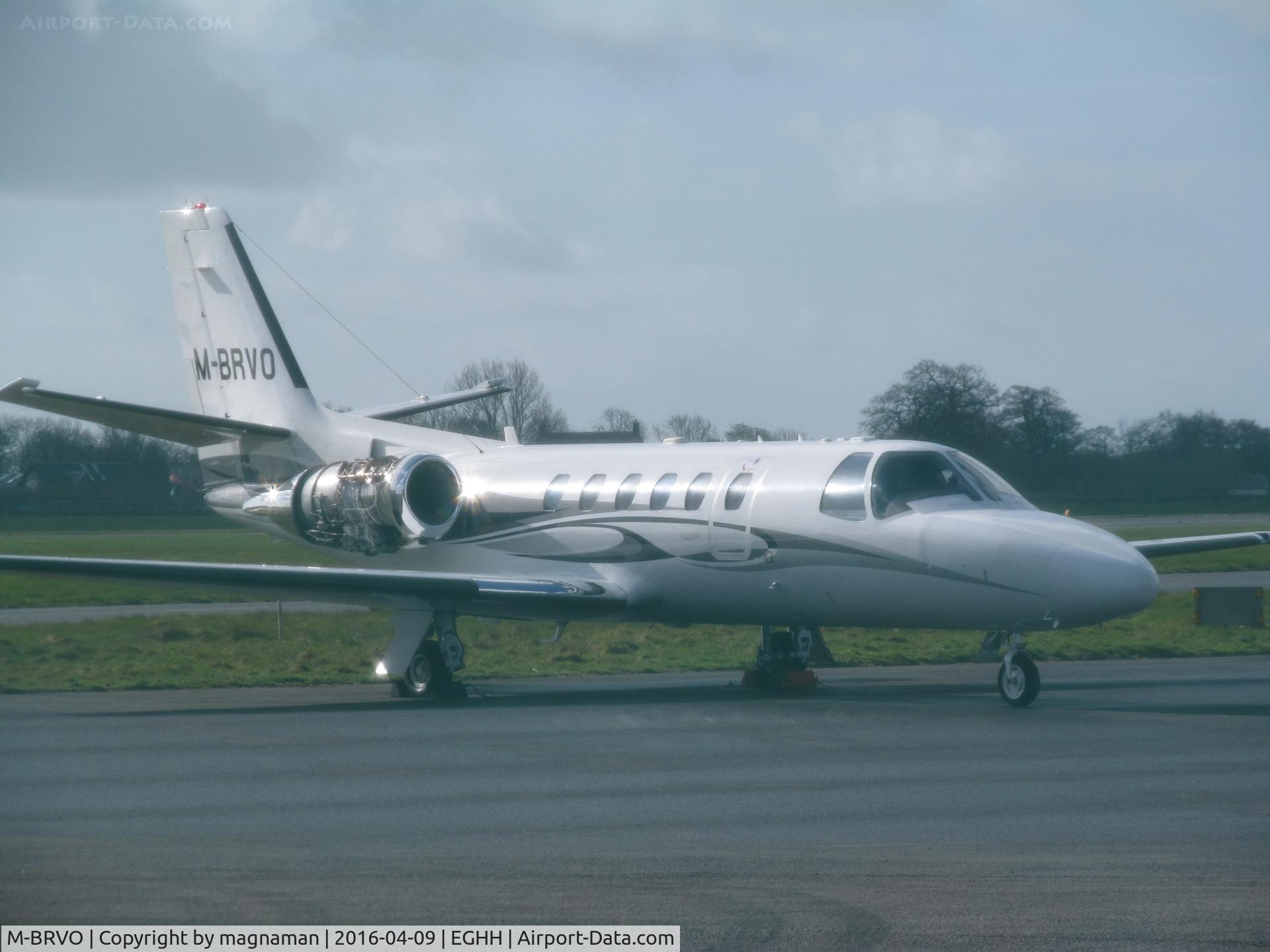 M-BRVO, 2006 Cessna 550 Citation Bravo C/N 550-1129, taken through green mesh so an odd photo look! Outside citation centre - hurn