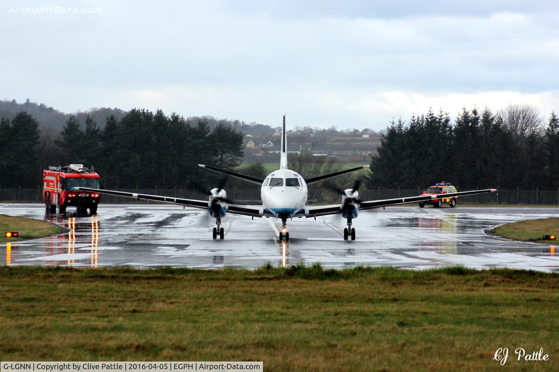 G-LGNN, 1990 Saab 340B C/N 340B-197, Being escorted to the terminal by emergency crews at Edinburgh EGPH following a precautionary return and landing after the pilot reported smoke in the cockpit.