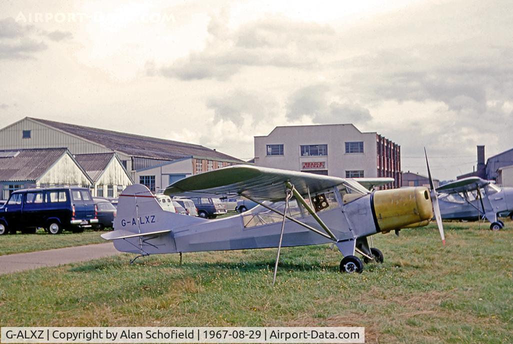 G-ALXZ, 1944 Taylorcraft Auster Mk.5/150 C/N 1082, This colour image was taken at Rearsby by Alan Schofield dated 29 August 1967 and was deliberately composed to include Beagle's motley array of buildings inherited from Austers and Taylorcraft before that!