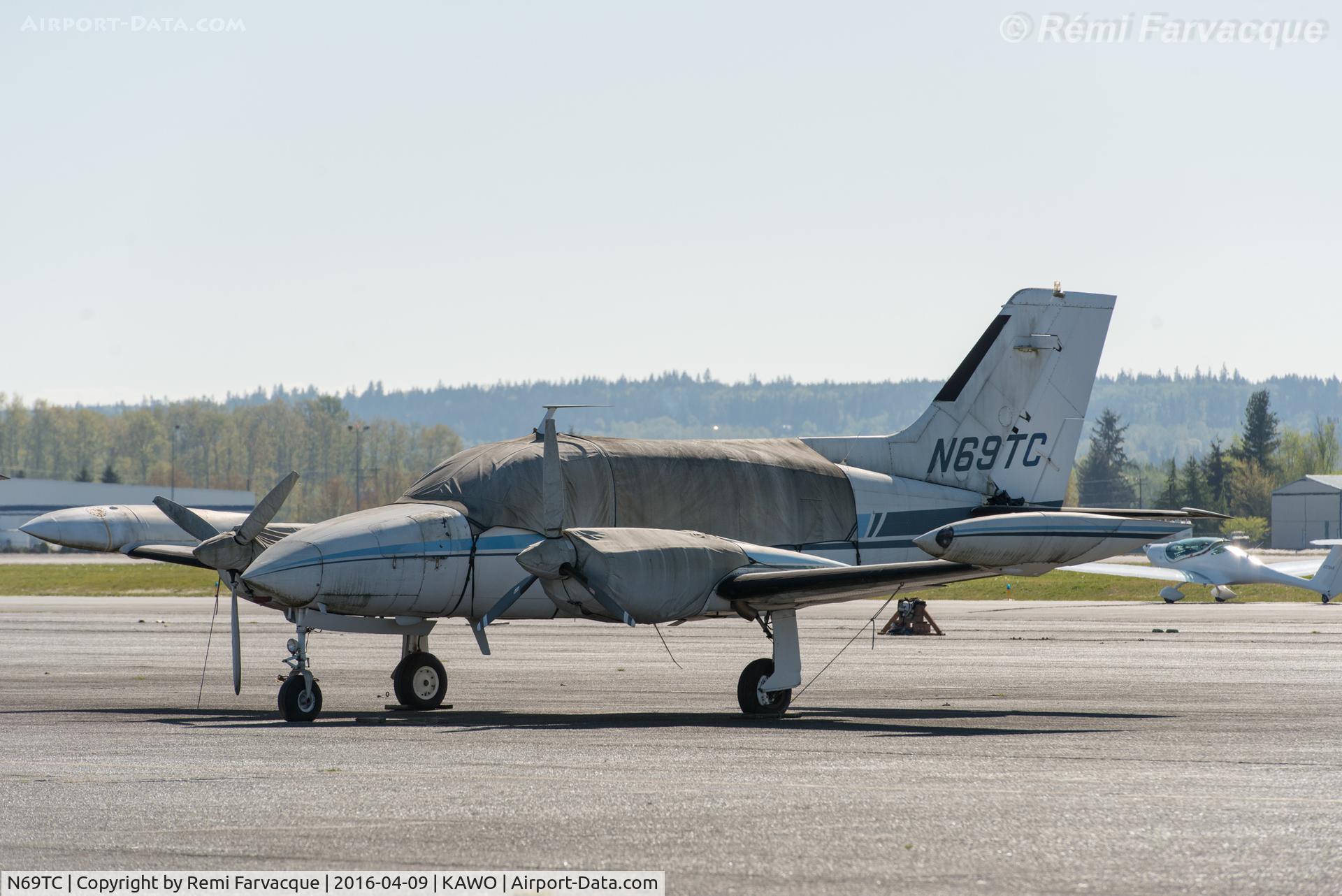 N69TC, 1969 Cessna 421A Golden Eagle C/N 421A0059, Parked near main terminal building at KAWO (AWO).
