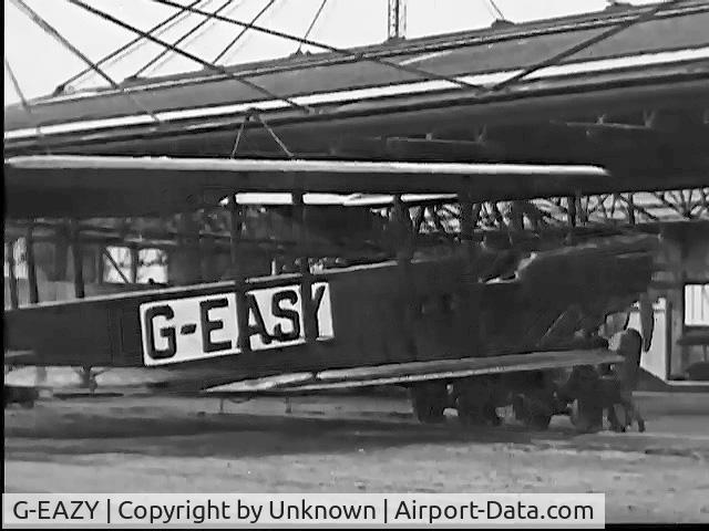 G-EAZY, Airco DH9 C/N H5706, Shows crew pushing G-EASY from London hangar, wings still folded, for English Channel Crossing in 1923. Still from public domain 1923 film, 