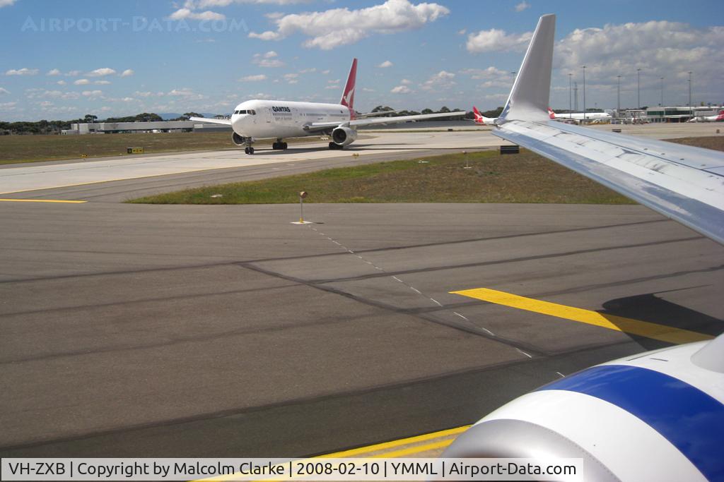 VH-ZXB, 1990 Boeing 767-336 C/N 24338, On Arrival at Melbourne on board Boeing 737-8FE VH-VUH from Launceston, Boeing 767-336 VH-ZXB taxi's alongside. Melbourne International Airport, February 2008.