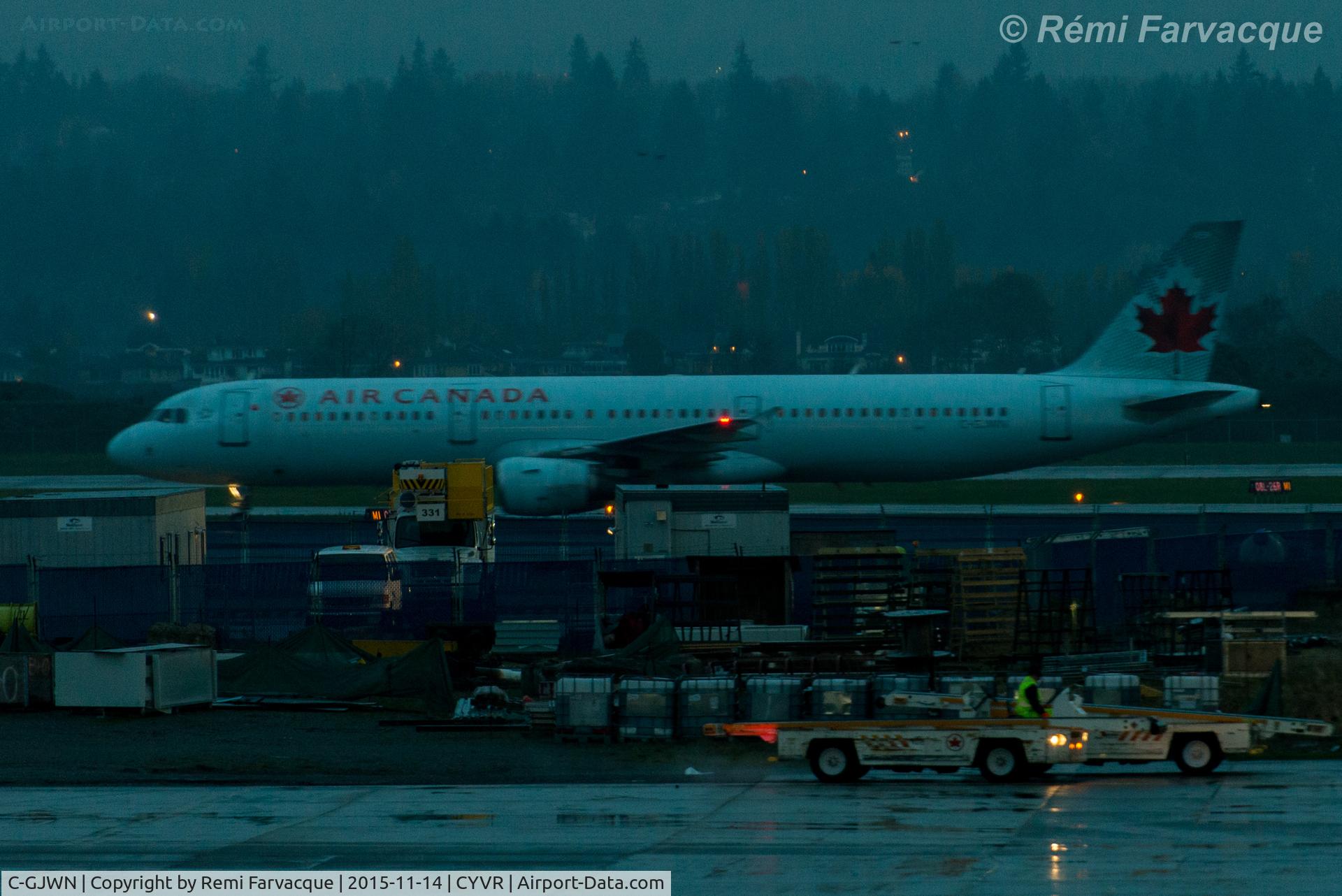 C-GJWN, 2002 Airbus A321-211 C/N 1783, Late dusk landing westerly on north runway. High ISO, low light and raining sorry for the blur :-)