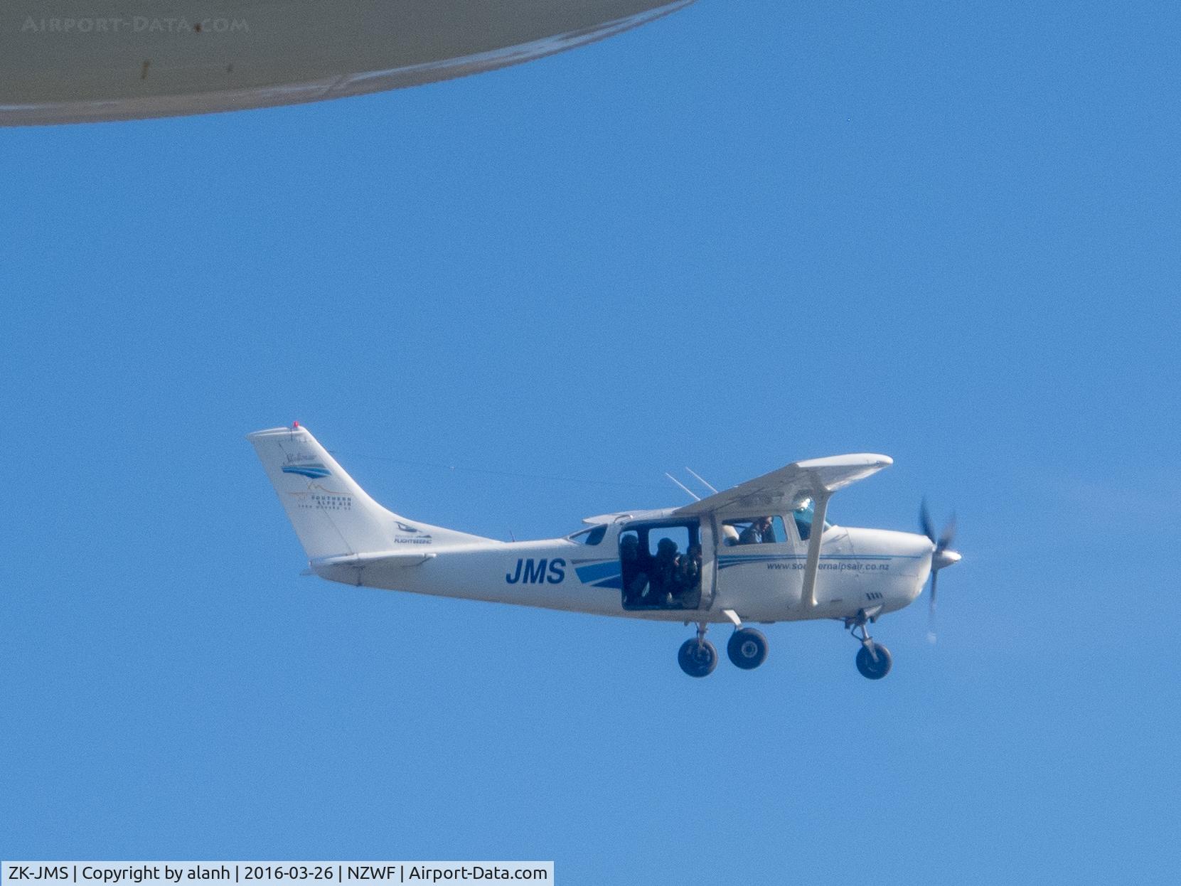 ZK-JMS, Cessna U206F Stationair C/N U20601838, Taken from ZK-PBY out of Wanaka, after the Saturday airshow. There are 3 photographers in the back of JMS shooting the Catalina. Wingtip float of PBY visible top left.