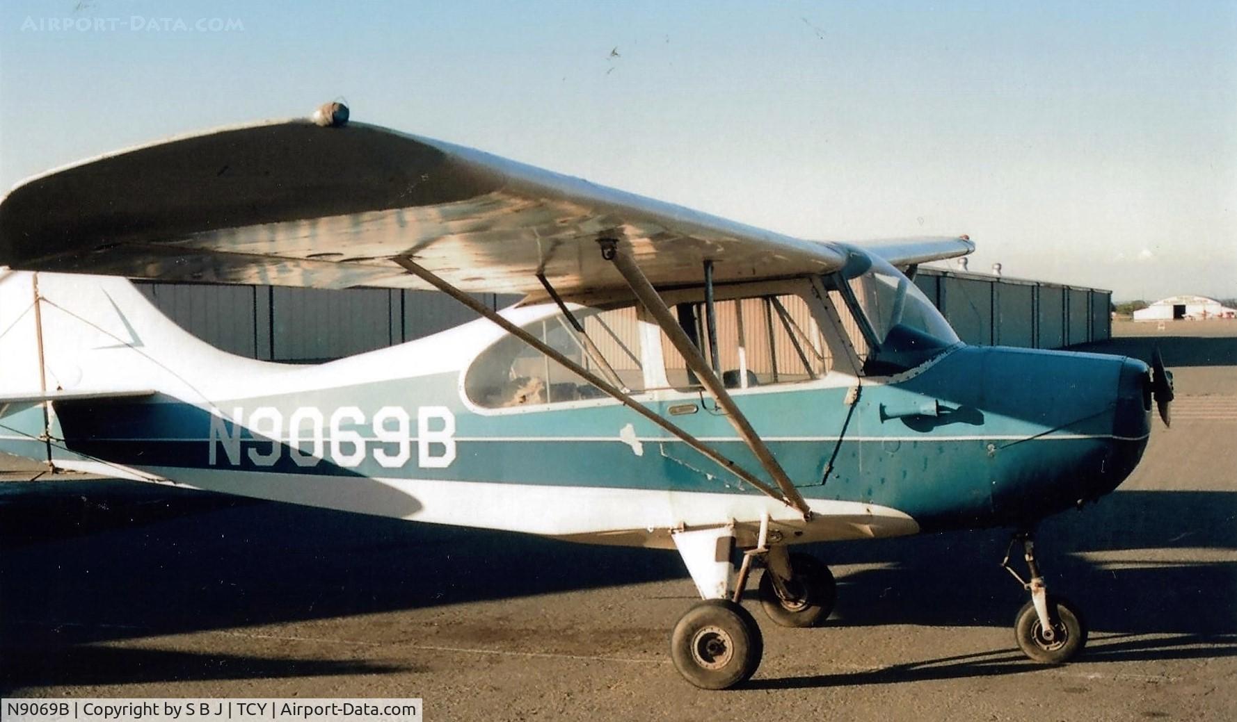N9069B, 1958 Champion 7FC C/N 7FC-153, 69B soon to be disassembled for rebuild. The big hangar at the Tracy airport is seen in the distance.