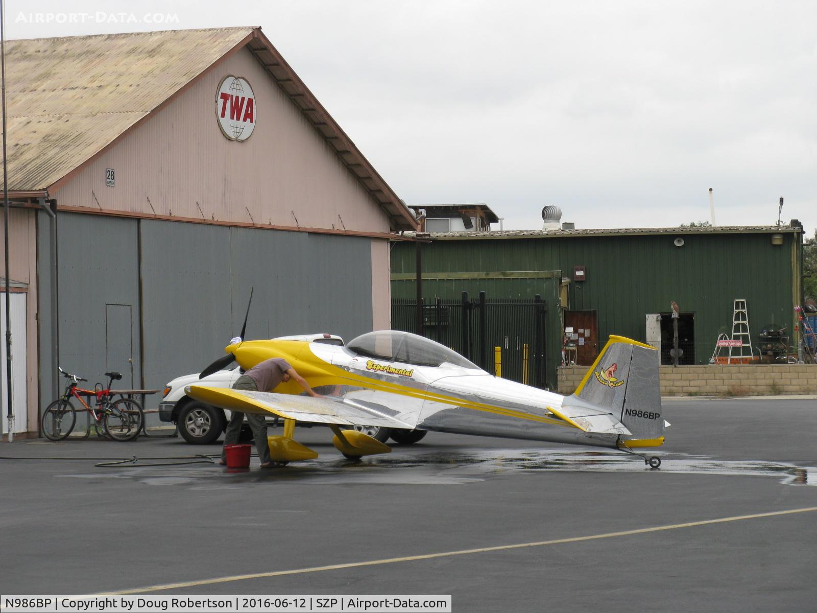 N986BP, 2013 Vans RV-4 C/N 4107, 2013 Stewart VAN's RV-4 'Banana Puddin', Lycoming O-320-D1A 160 Hp, hand washing aircraft on hangar ramp before local flights today. A gorgeous RV-4 build!