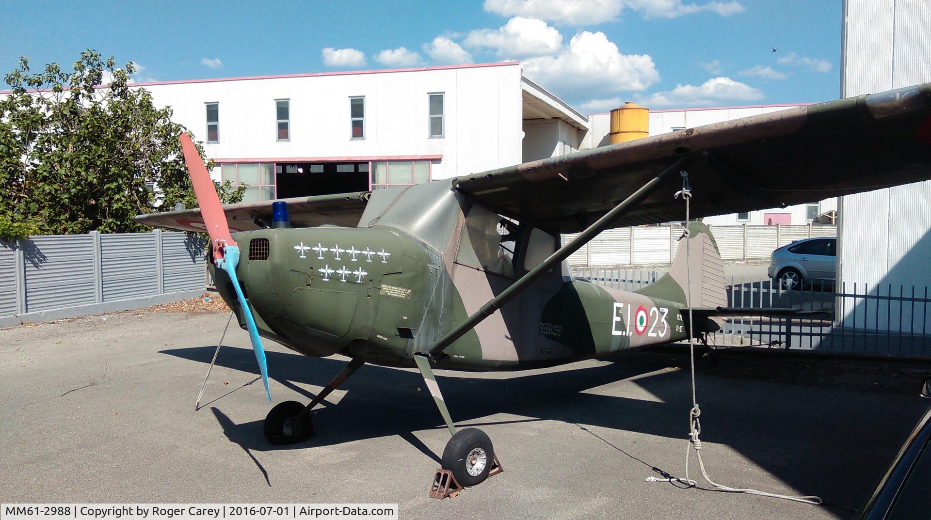 MM61-2988, 1961 Cessna O-1E Bird Dog C/N 305M-0036, On forecourt of Sanseplocro VW Audio dealership.