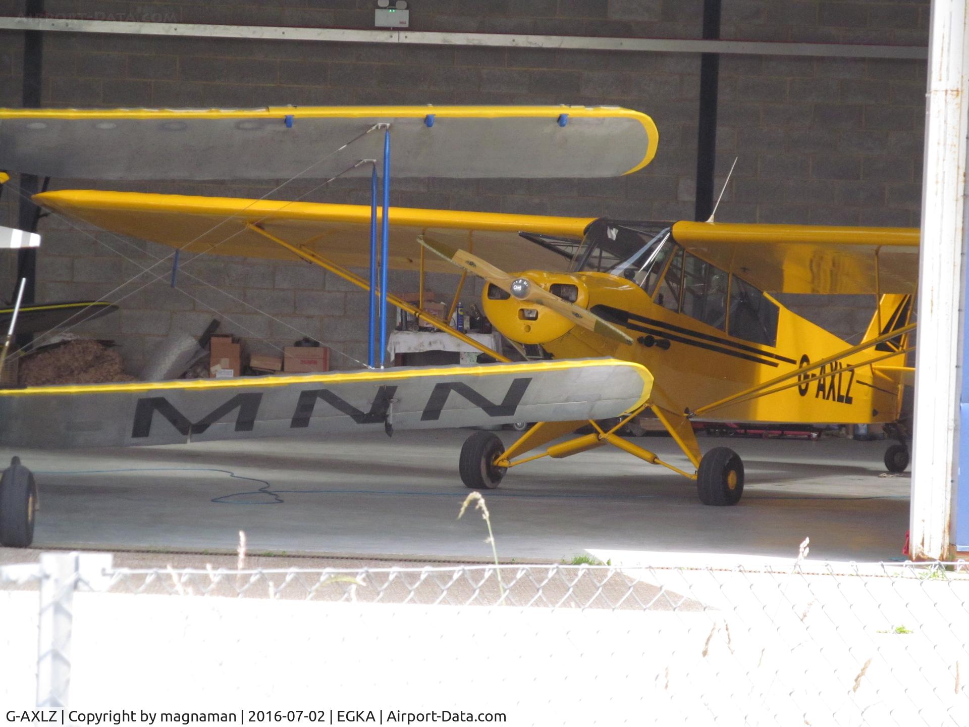 G-AXLZ, 1952 Piper L-18C Super Cub C/N 18-2052, in hangar with a few other oldies