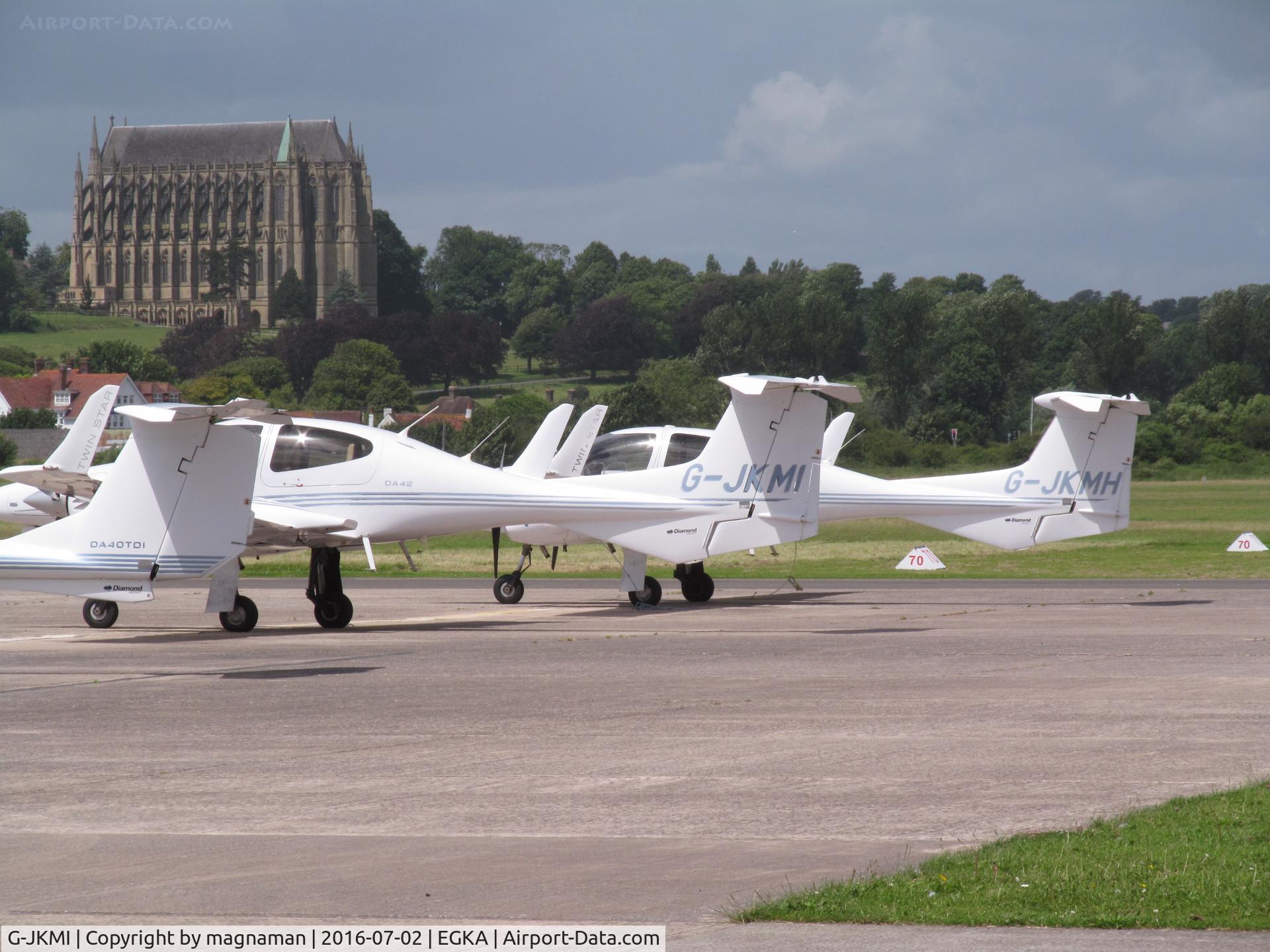 G-JKMI, 2005 Diamond DA-42 Twin Star C/N 42.051, with sister craft behind in front of lancing college on hill