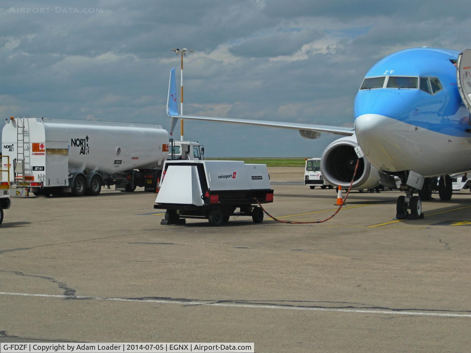 G-FDZF, 2008 Boeing 737-8K5 C/N 35138, G-FDZF on stand at East Midlands Airport with the airport vehicles on the apron