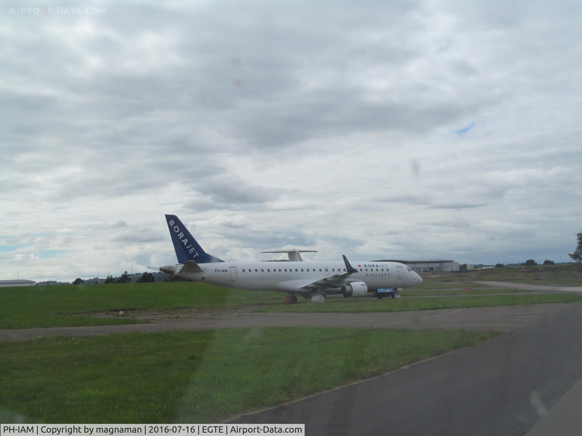 PH-IAM, 2009 Embraer 190AR (ERJ-190-100IGW) C/N 19000310, taken through car windscreen