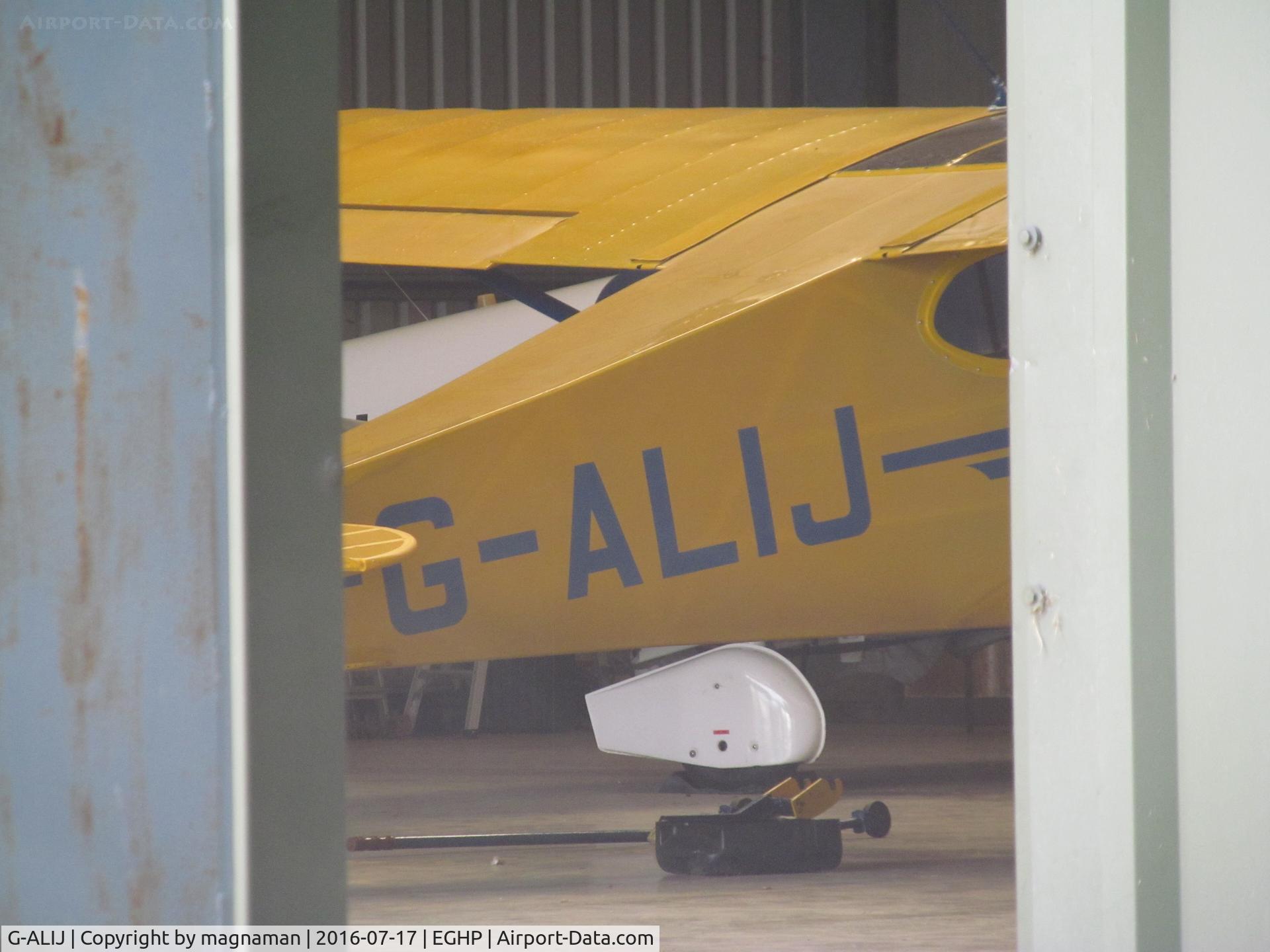 G-ALIJ, 1949 Piper PA-17 Vagabond C/N 17-166, Glimpse of old cub through hangar door
