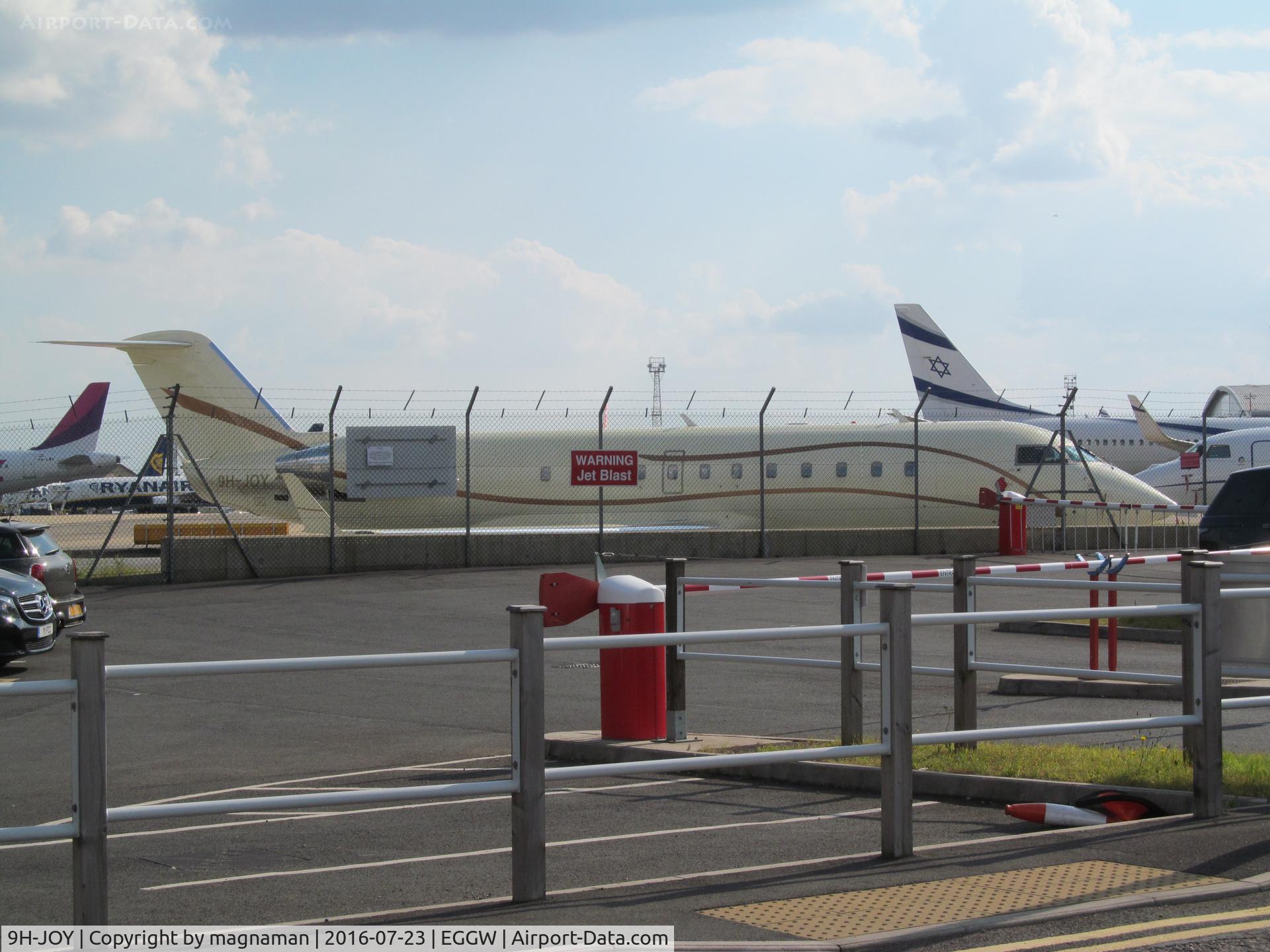 9H-JOY, 2002 Bombardier CRJ-200ER (CL-600-2B19) C/N 7644, across car park at luton