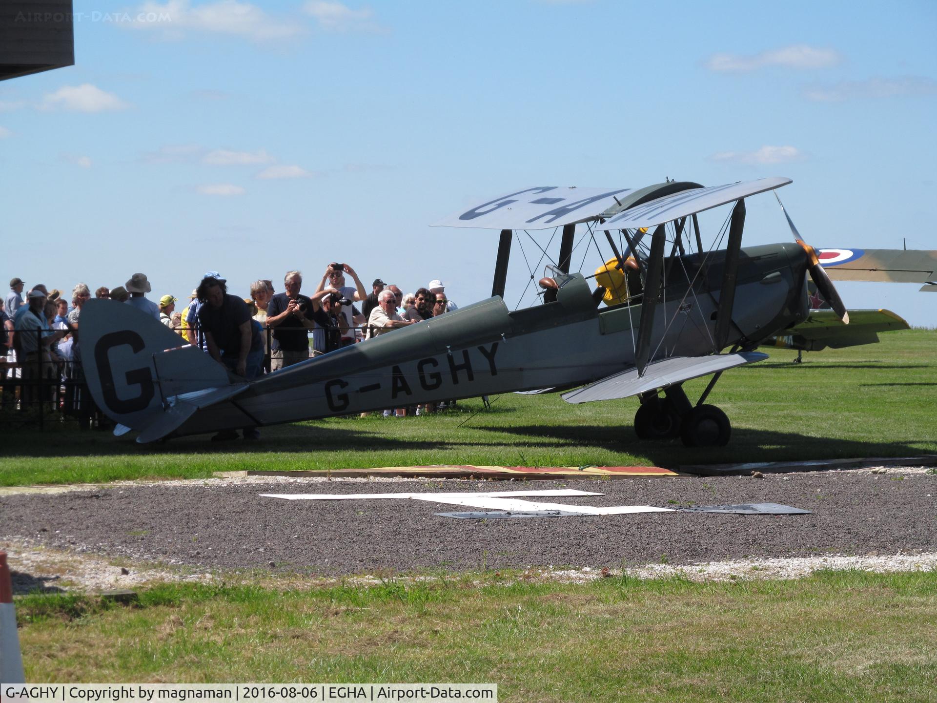 G-AGHY, 1939 De Havilland DH-82A Tiger Moth II C/N 82292, next to crowds at café compton