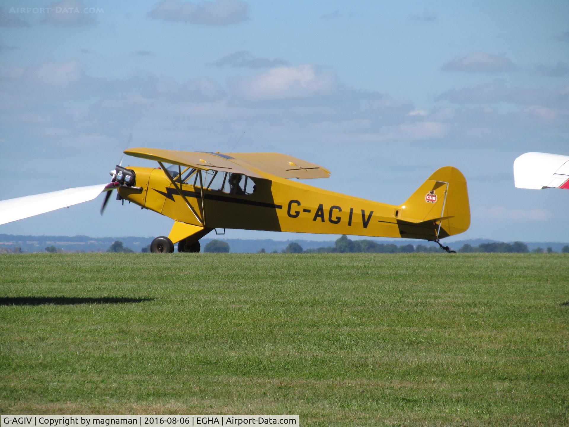 G-AGIV, 1944 Piper L-4J Grasshopper (J3C-65D) C/N 12676, taxying past a gap in line up