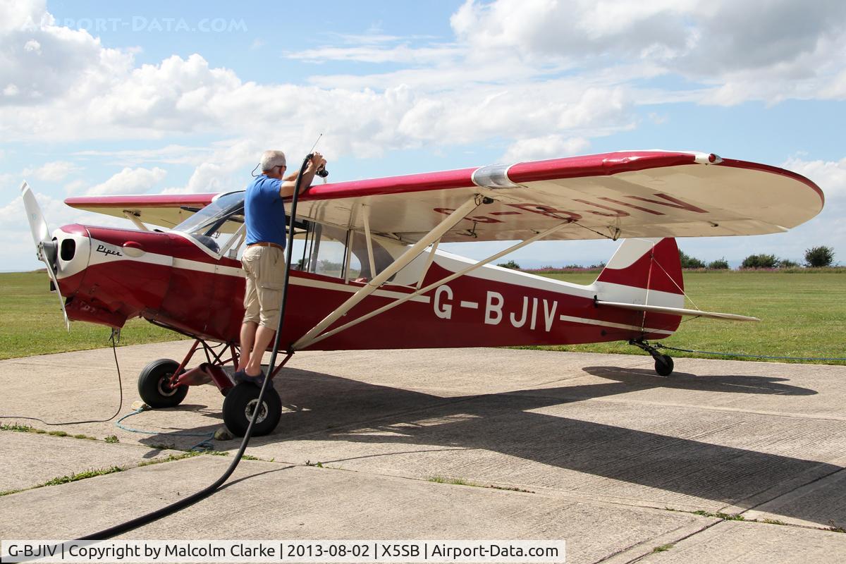 G-BJIV, 1965 Piper PA-18-150 Super Cub C/N 18-8262, Piper PA-18-150 Super Cub, one of the tugs at The Yorkshire Gliding Club being re-fueled, Sutton Bank, North Yorkshire, August 2013.