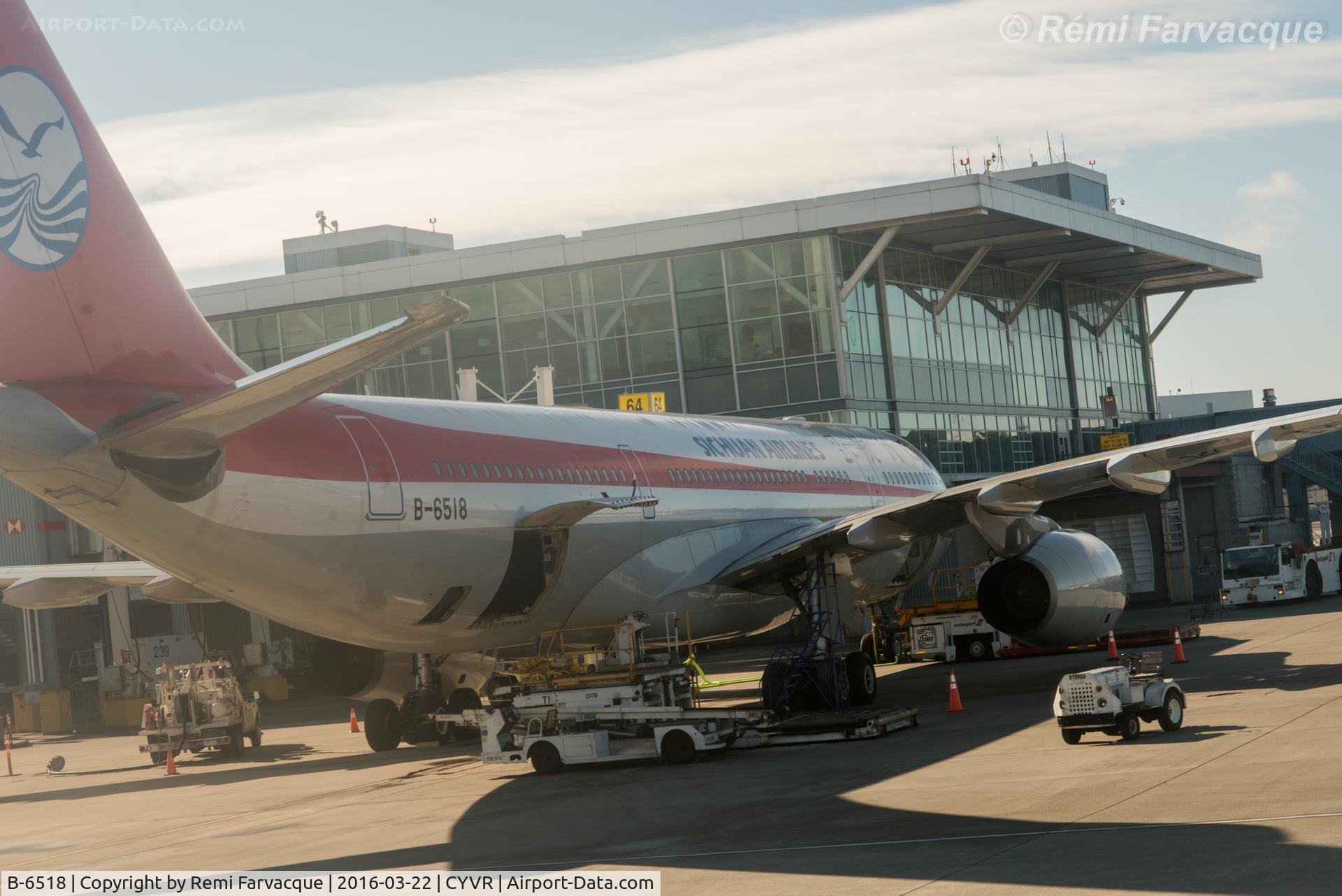 B-6518, 2010 Airbus A330-243 C/N 1082, Drive-by from another aircraft. Parked at International terminal.